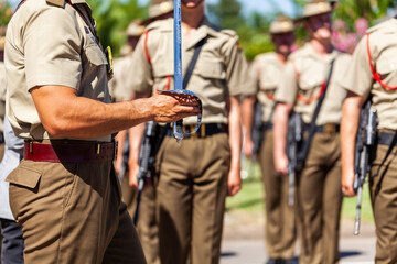 Australian army soldier with sword drawn for Freedom of Entry ceremony beside troops