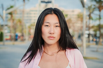 Close up individual portrait of happy asian young adult woman smiling with perfect white teeth....