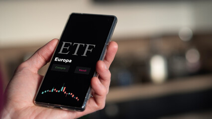 An Italian investor analyzing an etf fund on a phone. Italian text: Europe, buy, sell. © maurice norbert