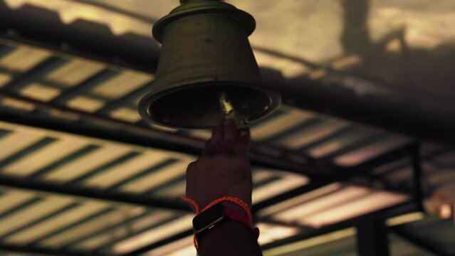 A temple bell ringing inside the temple during the invocation of deities