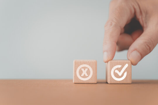 hand choose approved sign on wooden cube block, True and false symbols accept rejected for evaluation