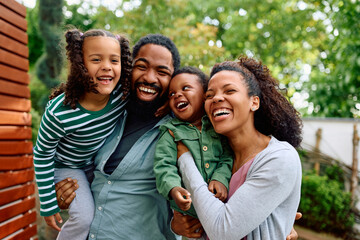 Portrait of cheerful black family enjoying in their time together.