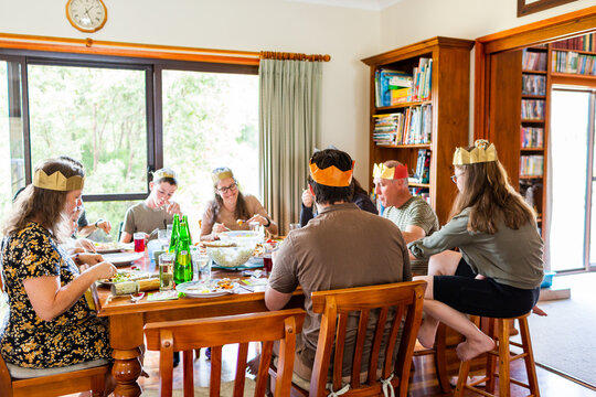 Happy family having Christmas lunch celebration with in-laws at home