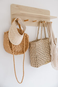 Bags and baskets hang on a rack.