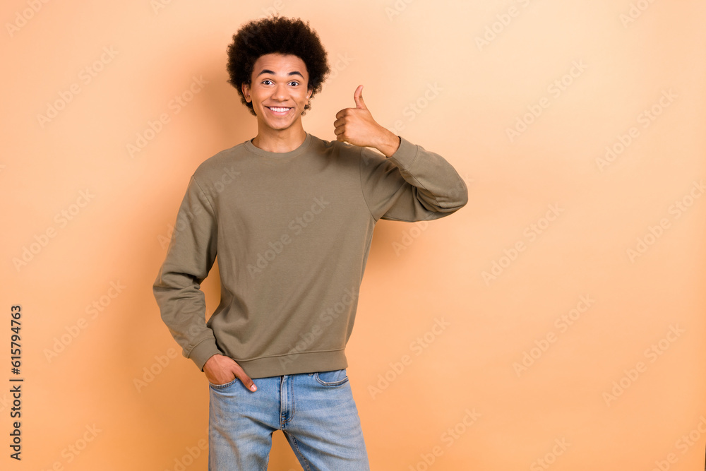 Canvas Prints Photo of young optimistic guy chevelure hair thumb up wear stylish pullover thumb up like new clothes brand advert isolated on beige color background