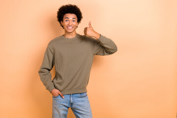 Photo of young optimistic guy chevelure hair thumb up wear stylish pullover thumb up like new...
