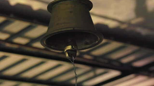 A temple bell ringing inside the temple during the invocation of deities