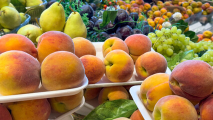 Grocery counter. Fresh fruits for sale. Close-up peach