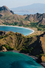 Panorama of Padar Island, in Indonesia, from a height, view of the bays, blue ocean, dry grass.