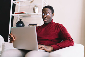 Stunned man with laptop resting
