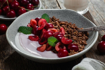 Granola with yogurt and cherries in a bowl
