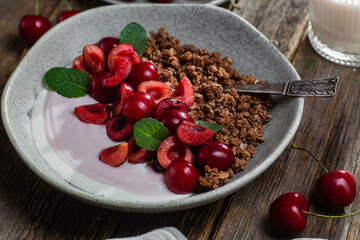 Granola with yogurt and cherries in a bowl
