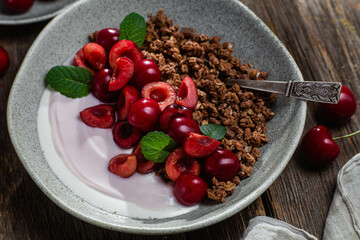 Granola with yogurt and cherries in a bowl
