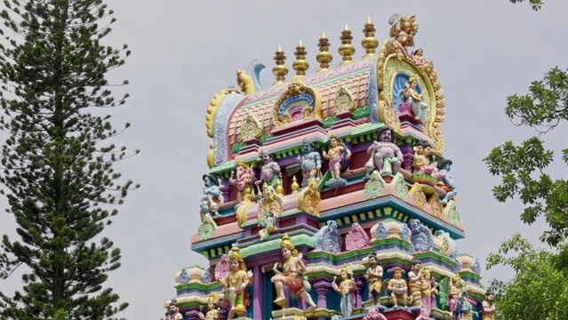 The Indian Hindu temple features a Shikhara adorned with sculptures of gods