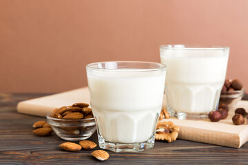 Set or collection of various vegan milk almond, cashew, on table background. Vegan plant based milk and ingredients, top view