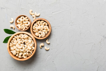 cashew nuts in wooden bowl on table background. top view. Space for text Healthy food