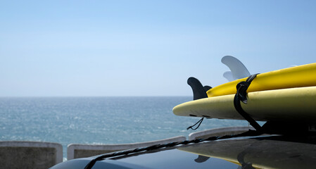 Naklejka na ściany i meble Surfboards loaded onto a car near the coast of Ericeira, Portugal