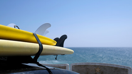 Surfboards loaded onto a car near the coast of Ericeira, Portugal
