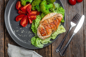 Baked chicken fillet with vegetables in a plate
