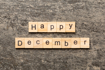 Fototapeta premium Happy december word written on wood block. Happy december text on table, concept