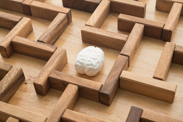 Human brain find search the exit way in wooden maze game background. Business problem solution for successful target, creative thinking new ideas, innovation, knowledge education concept.