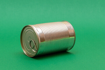 Unopened Tin Can with Blank Edge on Green Background. Canned Food. Aluminum Can for Safe and Long Term Storage of Food. Steel Sealed Food Storage Container