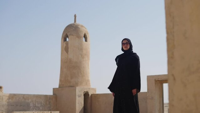 portrait of muslim woman at abandoned village al jumai Qatar
