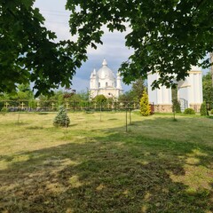 Fototapeta na wymiar A white church behind a fence