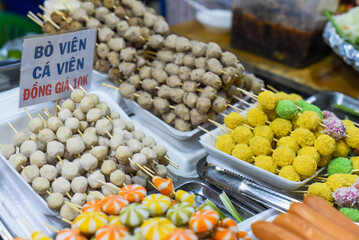 Many snacks and seafood in vietnamese night market in food festival, sign 