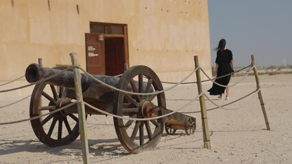 woman tourist visiting the ancient fortress of Al Zubarah at Qatar landmark
