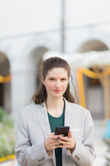 Girl checking smart phone content in a city street