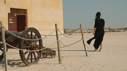 woman tourist visiting the ancient fortress of Al Zubarah at Qatar landmark
