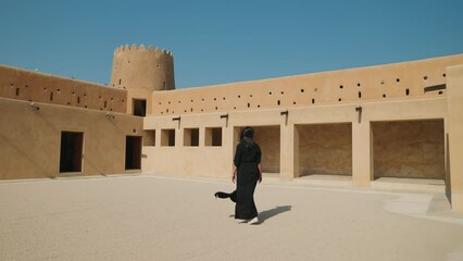 woman tourist visiting the ancient fortress of Al Zubarah at Qatar landmark
