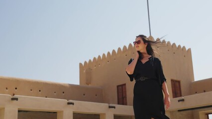 woman tourist visiting the ancient fortress of Al Zubarah at Qatar landmark
