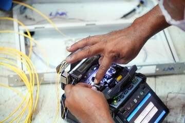 Technician working, fiber optic cable splicing and testing cables with optical power meter  - obrazy, fototapety, plakaty