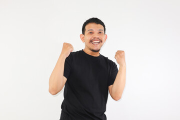Fototapeta premium Adult Asian man clenched fist showing excited expression, very happy and enthusiastic