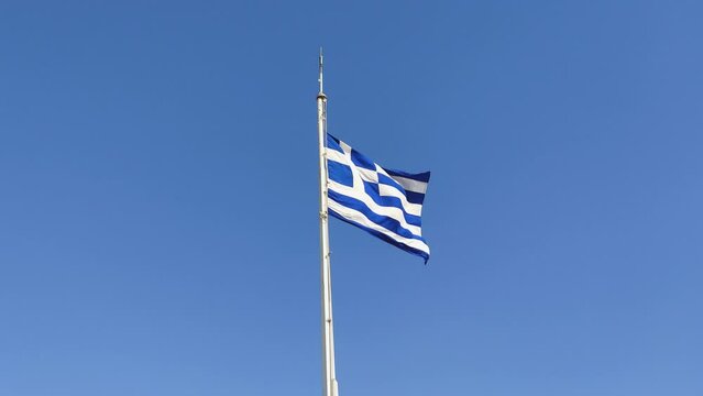 Greek Flag Waving Proudly Under the Bright Blue Sky on Parthenon Temple in Athens City, Greece, 4K Video Footage