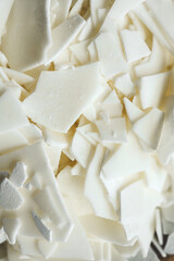 Close up of white soy wax flakes for candle making. Light texture of soy wax flakes. Ingredient for homemade candles. Ecological lifestyle