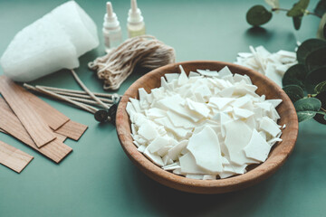 Soy wax candle, wooden wicks and eucalyptus, flat lay top view