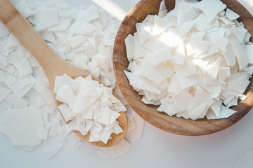 Soy wax on a wooden spoon. Natural, ecological, renewable, vegan. Soy candle wax