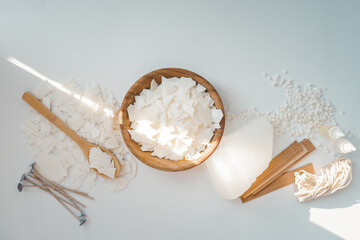 Set for crafting candle on white background. Eco soy wax and candle making tools top view, flat...