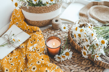 Candle and daisies, summer composition