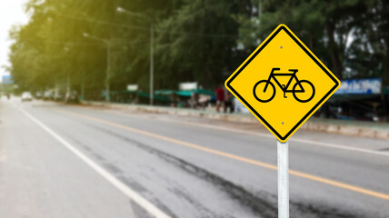 Yellow sign with graphic of bicycle to warn traffics to beware of bicycle lane