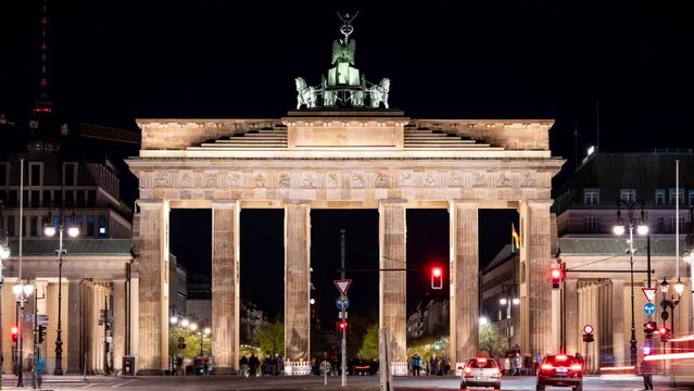 Timelapse video of cars driving past the famous Brandenburg Gate at night. Pariser Platz, Berlin, Germany.