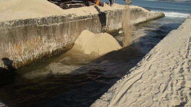 Excavator machine dredges on Ipanema Beach