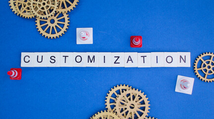 wooden gear teeth and cones with the word Customization. the action of modifying something to suit...