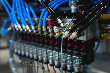 Pneumatic control board in production. Distributor of pneumatic control lines. Industrial photo