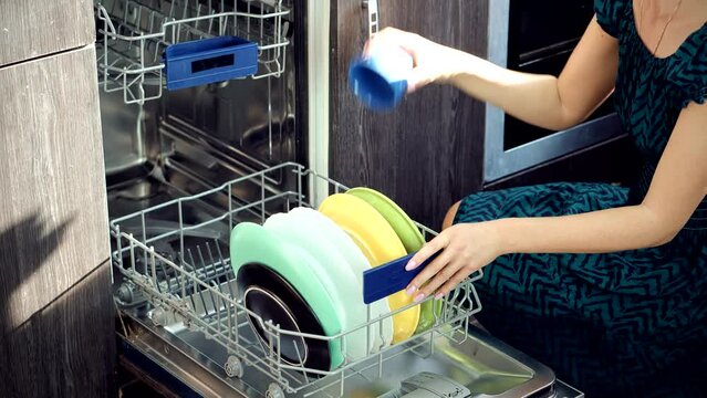 Housewife uses modern appliance to keep clean kitchen