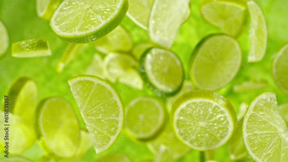 Aufkleber super slow motion of flying lime slices on green background. filmed on high speed cinema camera, 100
