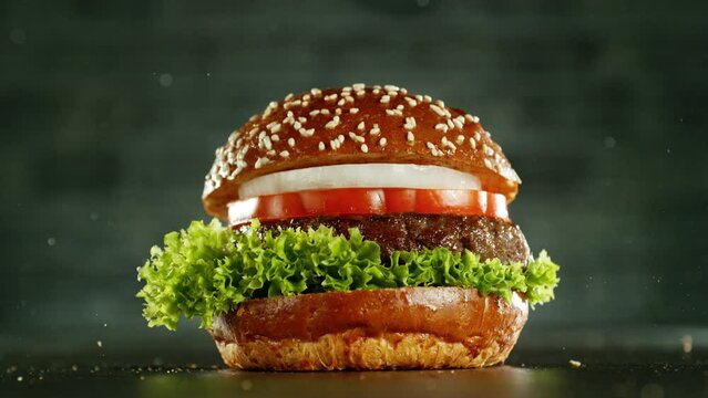 Super slow motion of stacking hamburger pieces. Camera in motion. Filmed on high speed cinema camera, 1000 fps. Placed on high speed cine bot. Speed ramp effect.